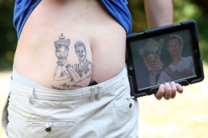 PIC BY MIKE JONES / CATERS NEWS - (PICTURED: Will Hirons tattoo) - A tennis fan has been left feeling sore after Andy Murrays Wimbledon victory - after getting the grinning Scot inked on his BUM. Tennis nut Will Hirons, from Hereford, told pals that if his favourite player, Murray, managed to make history and lift the trophy, he would get a tattoo of the moment on his backside. And when Murray triumphed on Sunday, Wills mates wouldnt let him forget the bet - and marched him to the tattoo studio. SEE CATERS COPY.